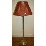 A brass standard reading lamp with adjustable arm and leopard print shade