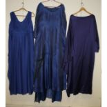 A blue sleeveless long evening dress, together with two other evening dresses Formally the property