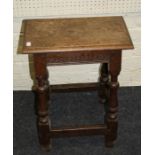 A late 17th century oak joint stool with lunette carved frieze and baluster supports joined by stret
