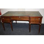 A Louis XVI mahogany bureau plat with inverted break front outline. Fitted with one long frieze one