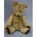 A 1930's musical teddy bear. Blond mohair with glass eyes, stitched nose and claws with felt pads. B