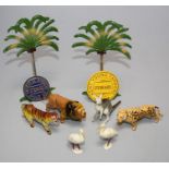 A small collection of die cast jungle and other animals, two palm trees, etc