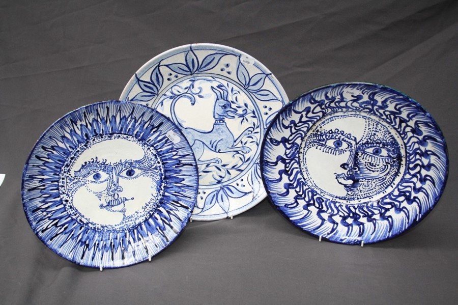 A Picasso- esque blue and white Spanish pottery plate painted with a radiant sun head design in coba