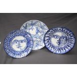 A Picasso- esque blue and white Spanish pottery plate painted with a radiant sun head design in coba