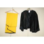 Sheila Ferst Couture. A black padded, sequined jacket together with a yellow cape Formally the prope