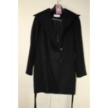 Calvin Klein. A black wool jacket, button and tie up belt Size large Formally the property of the la