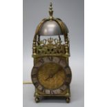 A large 17th century thirty hour brass lantern clock with high dome and bell and verge and wheel esc