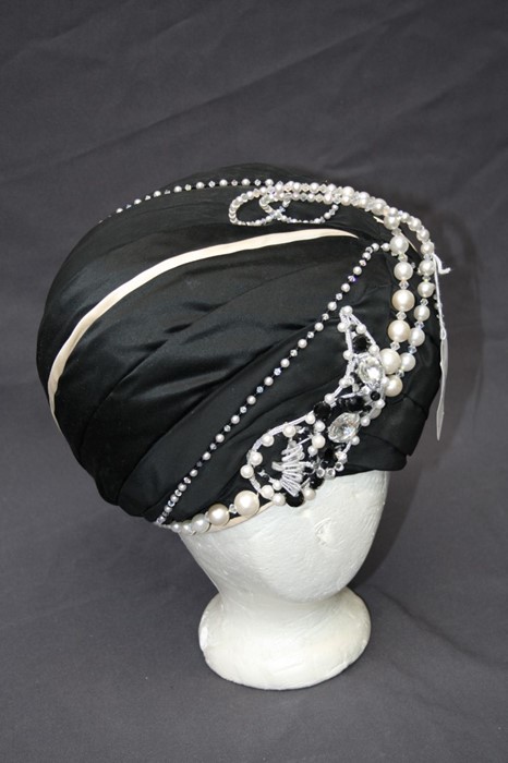 A black satin ladies turban hat Formally the property of the late Jessye Norman