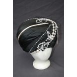 A black satin ladies turban hat Formally the property of the late Jessye Norman