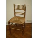 An Edwardian faux cane gilt painted rush seat bedroom chair