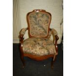 An 18th century French walnut fauteuil, with open arms, raised on slender cabriole supports