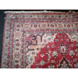 An Indian cotton pile carpet with geometric central lozenge design, 225 x 330cm