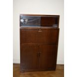 A mid 20th century Minty of Oxford bookcase cabinet having a pair of glazed sliding doors over a fit