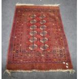 An early 20th century madder red Tekke Turkoman rug with a field of guls on a lattice ground. 150 x