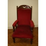 A Victorian oak, red plush upholstered salon armchair
