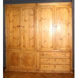 A large stripped and waxed 19th century style house keepers cupboard with six doors and a bank of dr