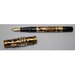 A Morrisons fountain pen, black with pierced gilt overlay and 14ct gold nib