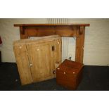 A stripped pine fire surround, stripped pine single door wall cupboard and a mahogany instrument box