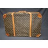 A large vintage Louis Vuitton suitcase with distinctive all over LV motif. 79 x 54cm Formally the p