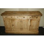 A 19th century stripped pine scullery dresser fitted three frieze drawers and four cupboard doors be