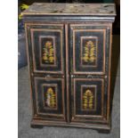 An Indian painted two door cabinet decorated with naive floral designs. 41cm wide Formally the prop