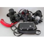 A group of cameras and accessories. To include: a Zeiss Icon, a Pentax ME Super, two Pentax MVs, a