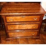 A George III revival mahogany crossbanded chest of drawers, rectangular moulded edge top, above