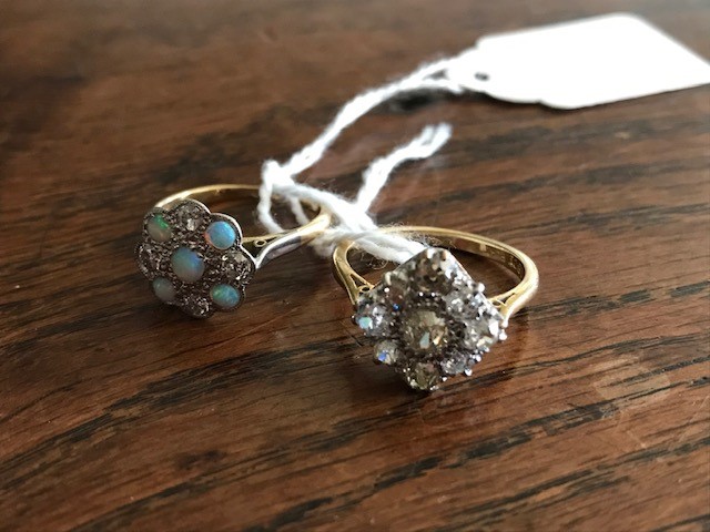 An 18ct gold and platinum set old cut diamond cluster ring, and an opal and diamond cluster ring (2)