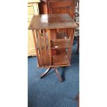 An Edwardian mahogany revolving bookcase, raised on quartet saber supports. 80cm H