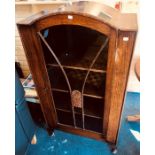 An early 20th Century oak glazed display cabinet, raised on short cabriole legs. 135cm H