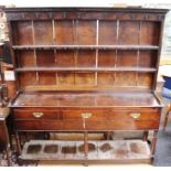 An 18th Century oak dresser, the rack with moulded cornice above a plain frieze fitted with game