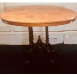 A Victorian walnut oval small loo occasional table, on turned supports, raised on splayed feet on