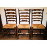A set of six 19th Century and later elm and ash ladderback rush seated chairs, in a Lancashire