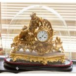 A French ormolu figural mantel clock on stand with glass dome, surmounted by a female figurine