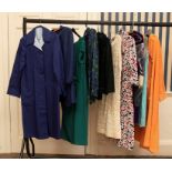 Ten items of 1950s/60s/70s items of clothing to include: A navy raincoat, long jacket, a jade