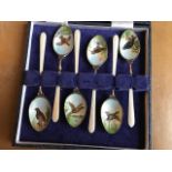 A cased set of six modern silver gilt and enamel teaspoons, decorated with birds