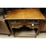 A George III style oak lowboy, fitted with a single drawer over two small drawers, raised on
