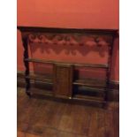 A 19th century oak carved wall hanging shelves, moulded cornice, three graduated shelves fitted with