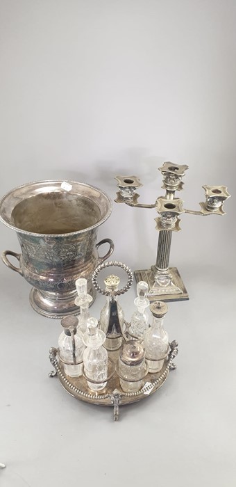 A seven piece Cruet on silver plated stand with top handle and supports, together with a plated