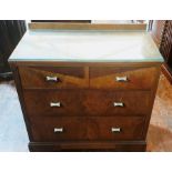 An Art Deco walnut chest of drawers, circa 1930, rectangular top with a glazed top with quarter