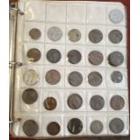 A coin album containing various coins including cartwheel penny, silver coins, 19th century and