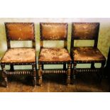 A set of six 17th century style oak leather seated chairs, brass studs fitted around the leather