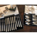 Two cases of hallmarked silver flatware, (a dessert set and grapefruit set), five silver napkin
