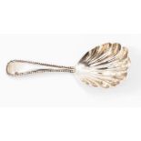 A late Victorian old English beaded pattern silver tea caddy spoon, shell bowl, London 1894,