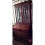 A George III mahogany bureau bookcase, circa 1780, the cabinet enclosing three adjustable shelves,