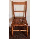 An Edwardian mahogany and oak cane seated chair