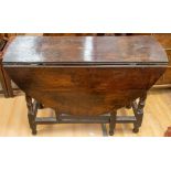 A 17th/18th Century oak gateleg drop-leaf table, the plain oval top raised on turned supports and