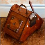 A Victorian walnut and brass coal skuttle with a brass shovel.