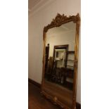 A large 20th Century gilt framed wall looking glass of Rococo design, approximate dimensions in full