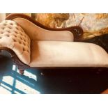 A late Victorian and later mahogany chaise longue, circa 1890, scrolling arm and a curve back,